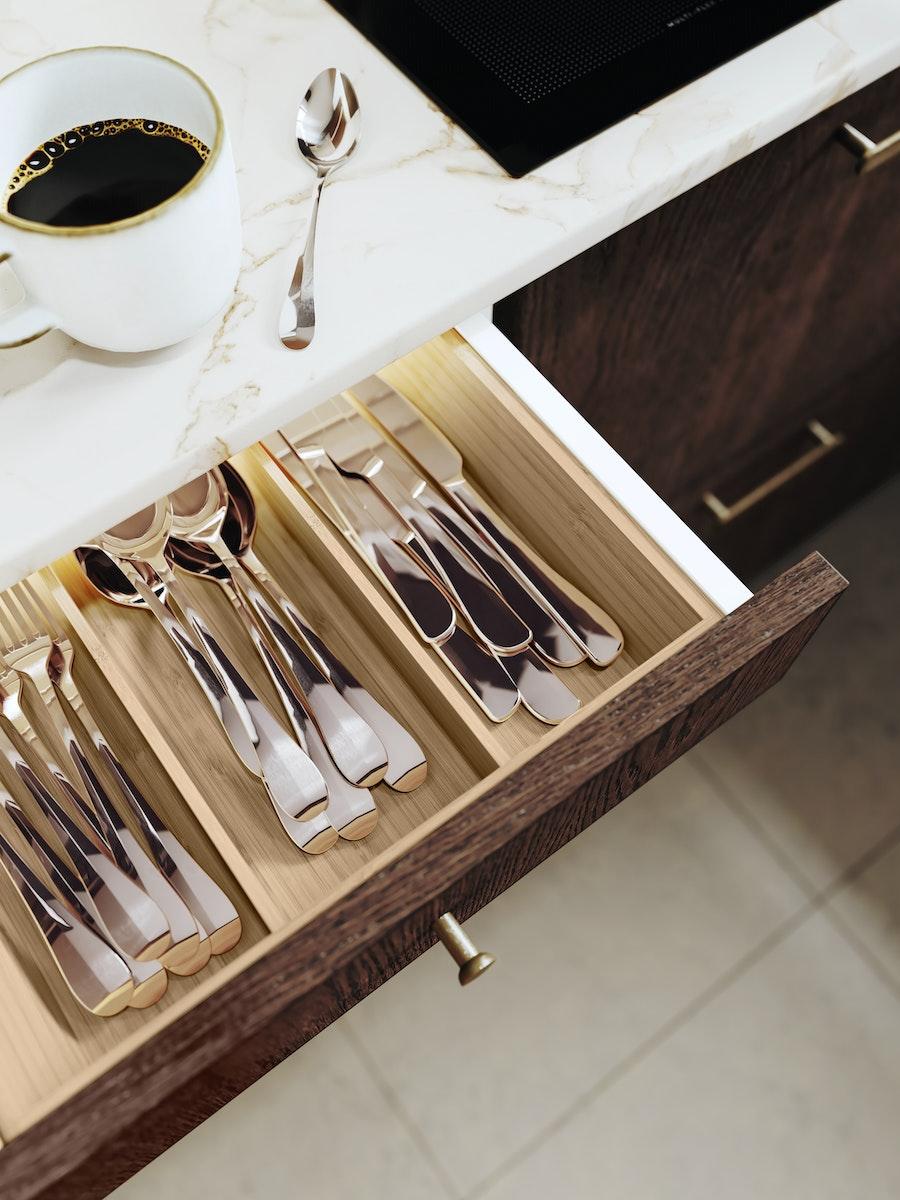 Open kitchen drawer with cutlery