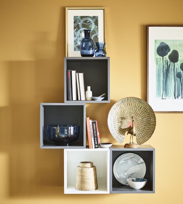 Open wall cabinets display decorative items and artwork.