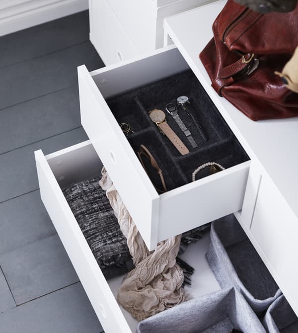 Open white drawers showing organization solutions for accessories