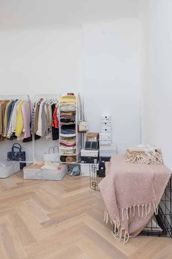Organised clothing and accessories storage system with drawers and shelves against the wall.