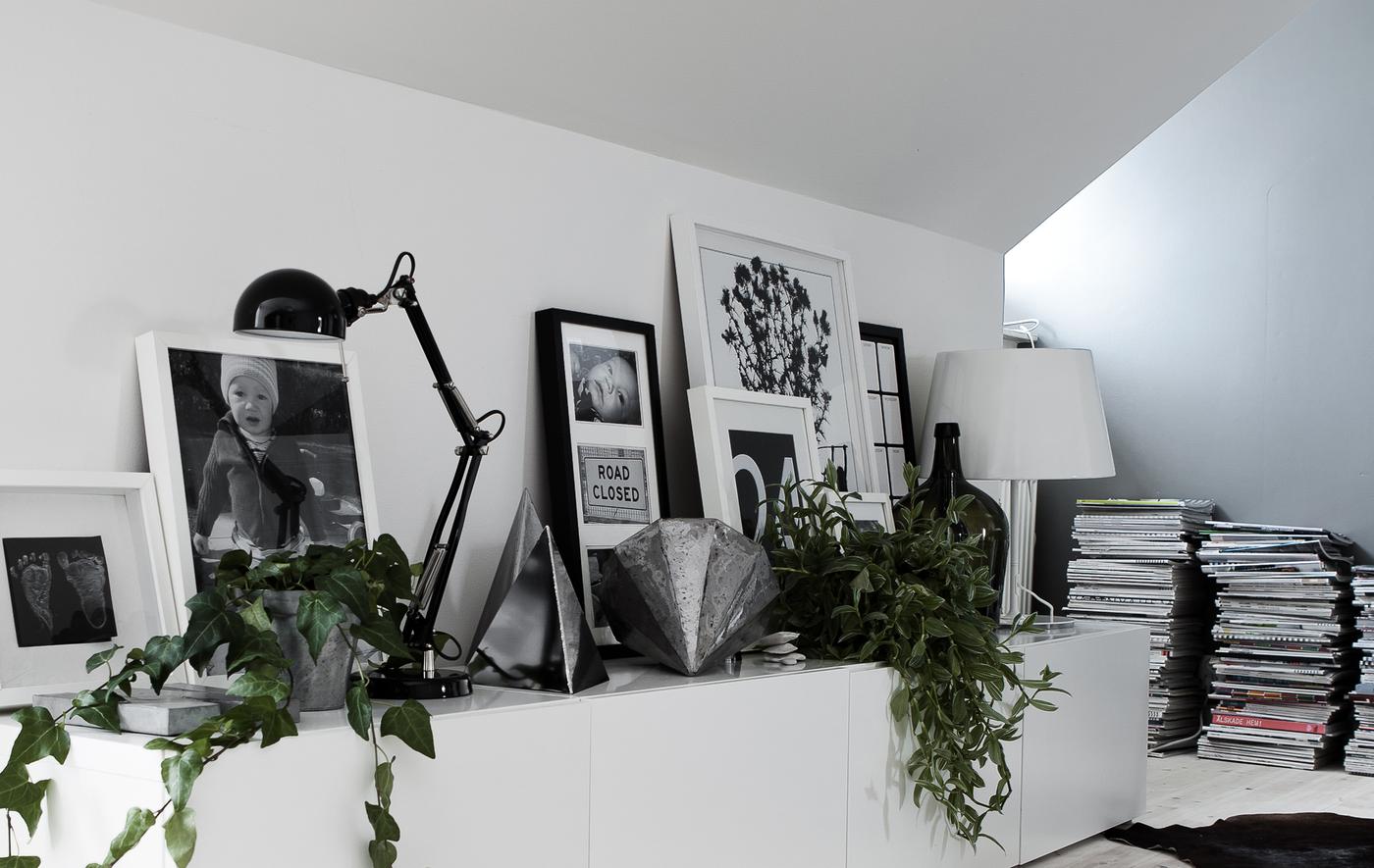 Overlapping picture frames, lamps and ornaments make a stunning shelf display.