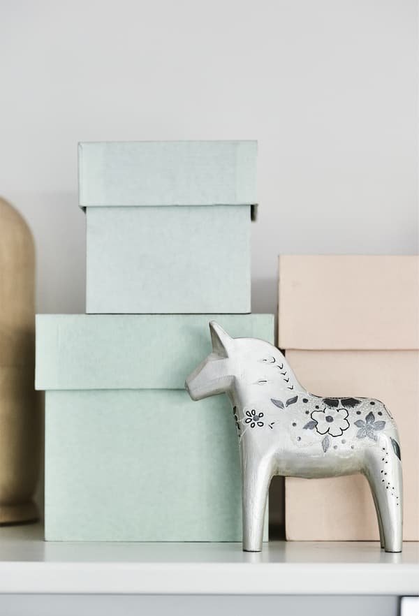 Pastel storage boxes stacked on a shelf.