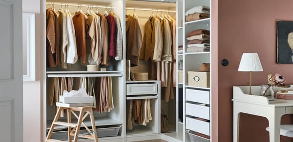 PAX unit. White, no doors, peach/beige walls with red rug and light hardwood floors.