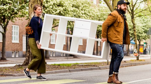 people carrying bookshelf