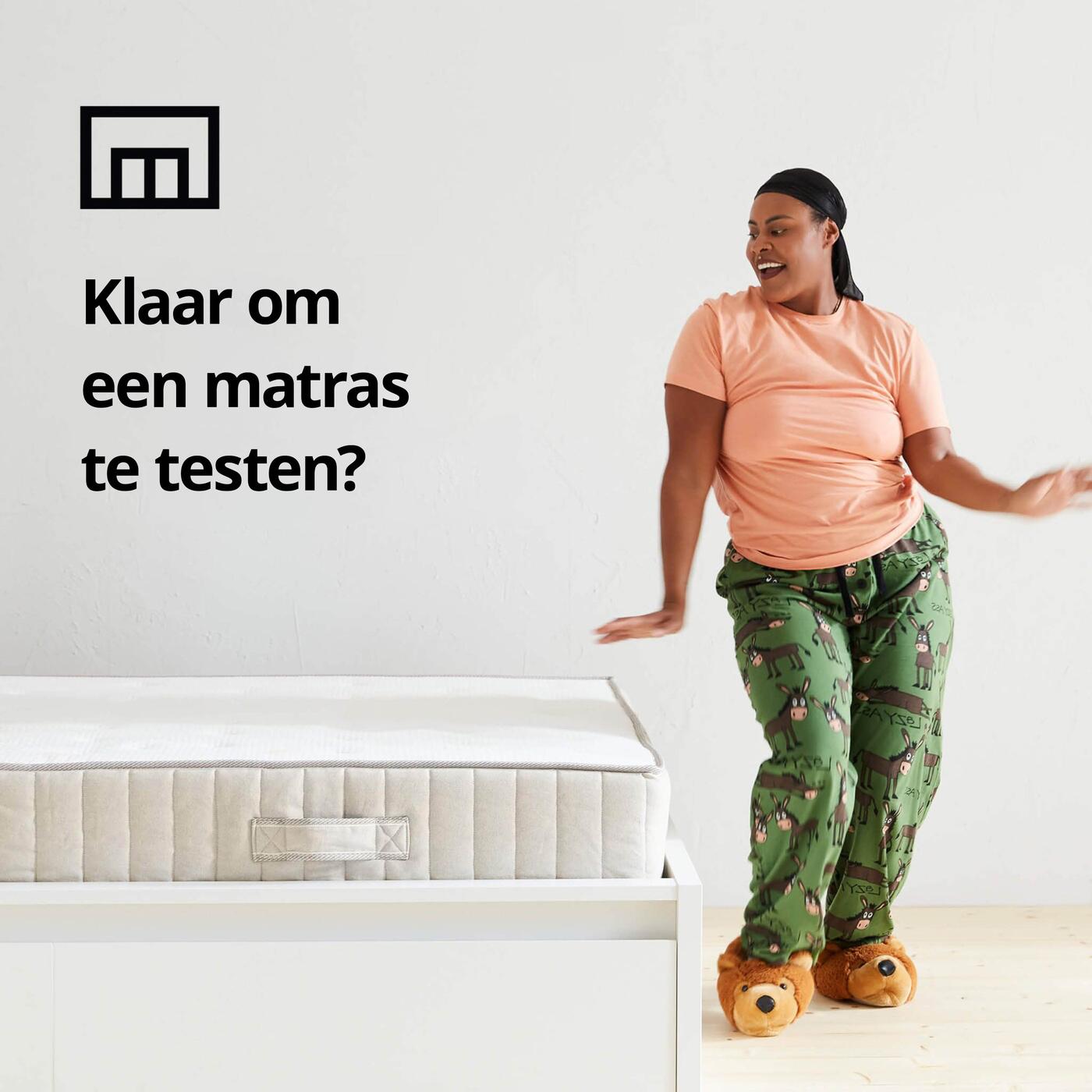 Persoon staat in pijama naast een bed, met de tekst: "klaar om een matras te testen?"
