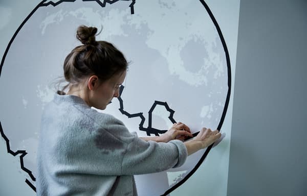 Picture of Agnes hanging fabric on a wall