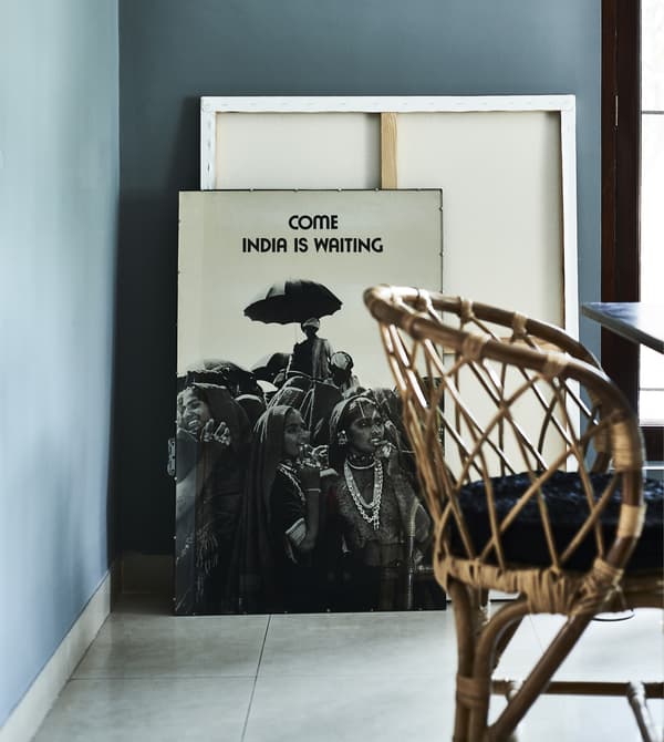 Pictures leaning against a blue wall.