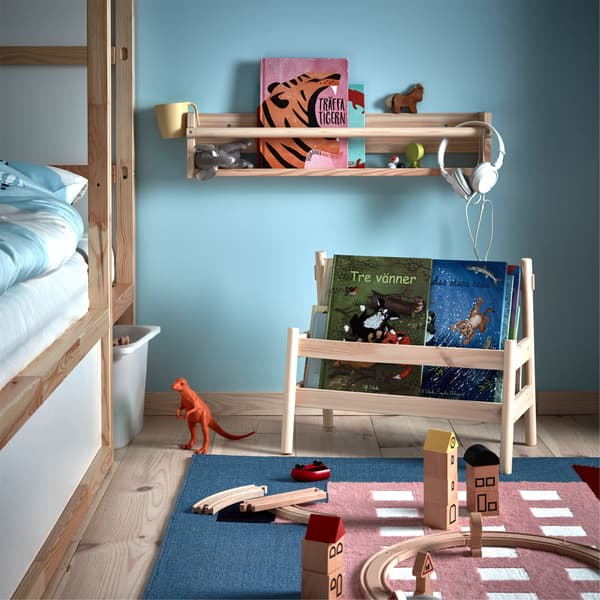 Placed by a children's bed is both FLISAT book display and wall storage and they store books and toys.