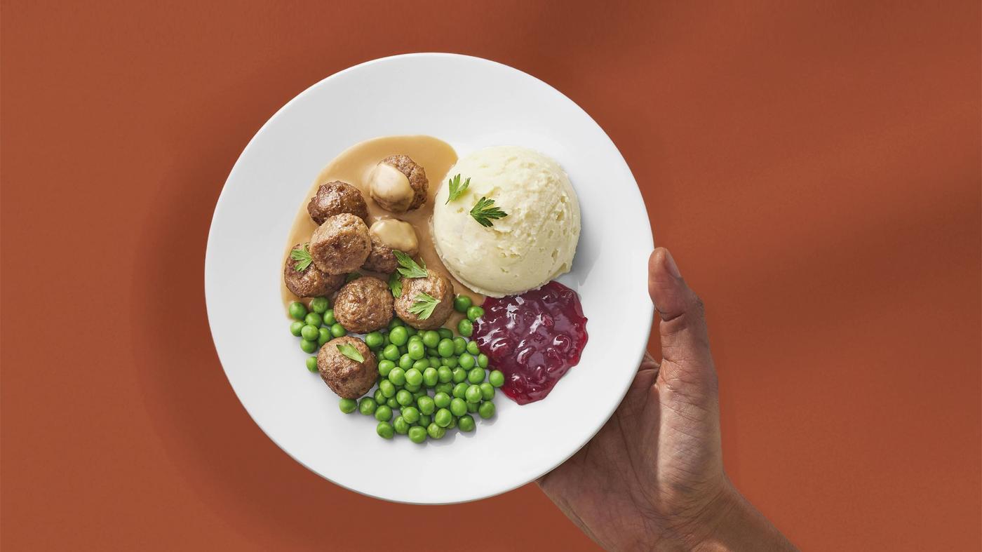 Plate with meatballs, mashed potatoes, peas, and lingonberry sauce