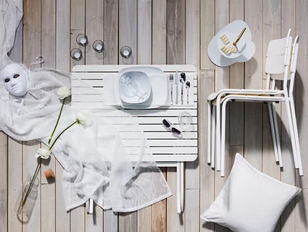 Présentation d’un kit dîner tout en blanc aux lignes modernes et épurées et des textiles assortis, vaisselle avec plat de présentation.