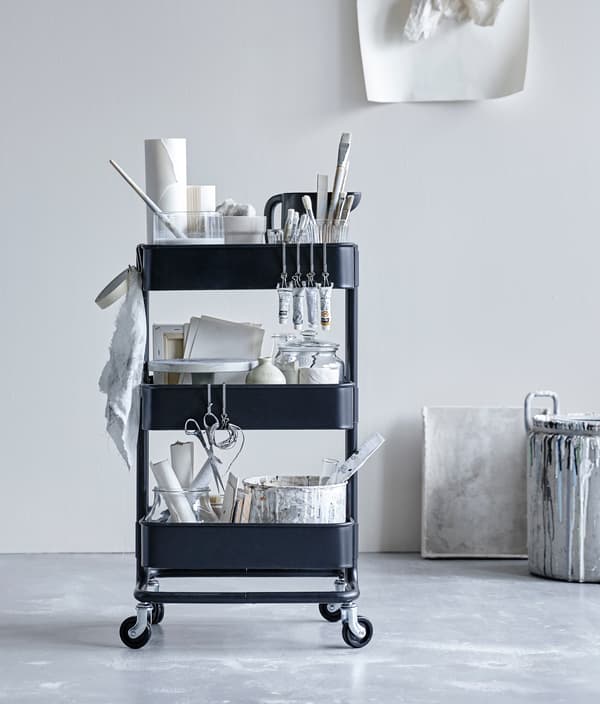 RÅSKOG trolley being used as an art station for painting and supplies.