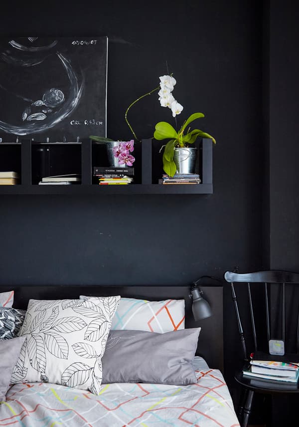 Replace bedside table with shelves above the bed to save floorspace.