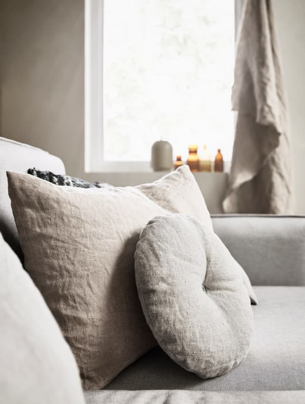 Round and rectangular pillows decorating a sofa.