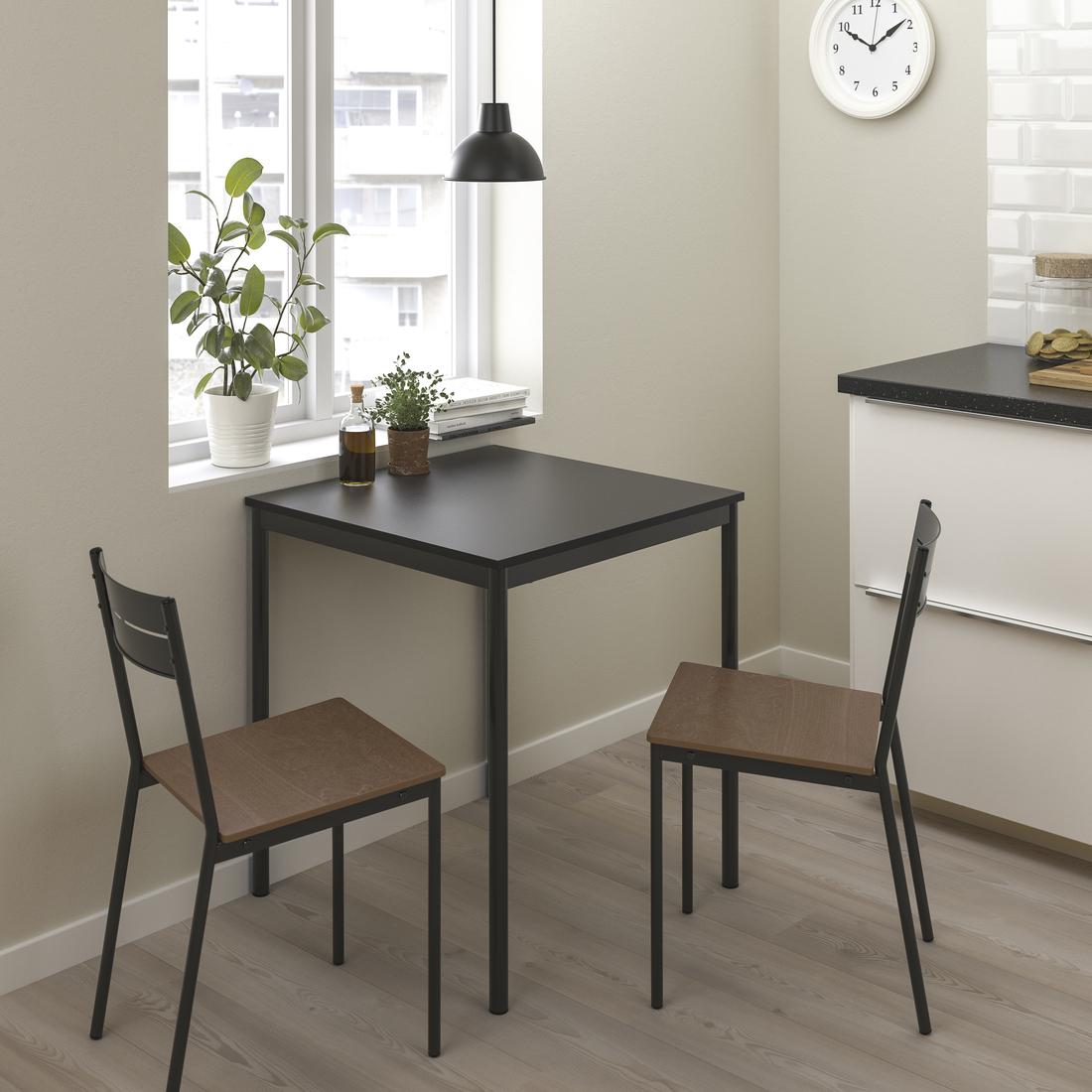 SANDSBERG dining series in small space dining room with two SANDSBERG chairs at a table.