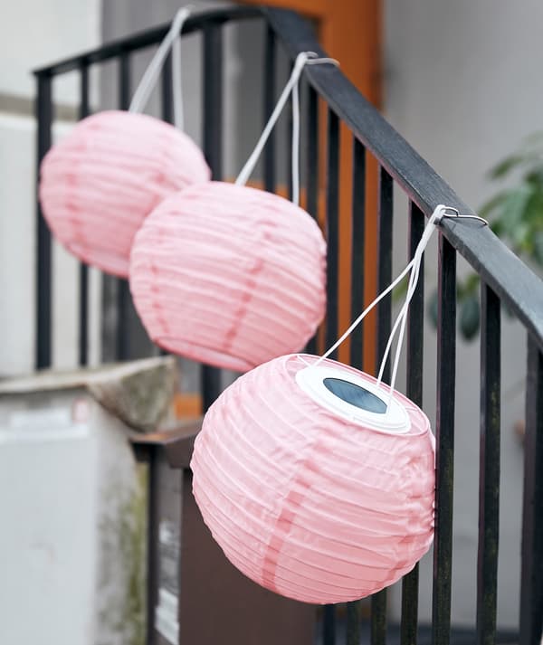 Sebaris lampu SOLVINDEN tergantung di sepanjang susur tangan tangga pendek yang menuju ke pintu masuk bangunan.