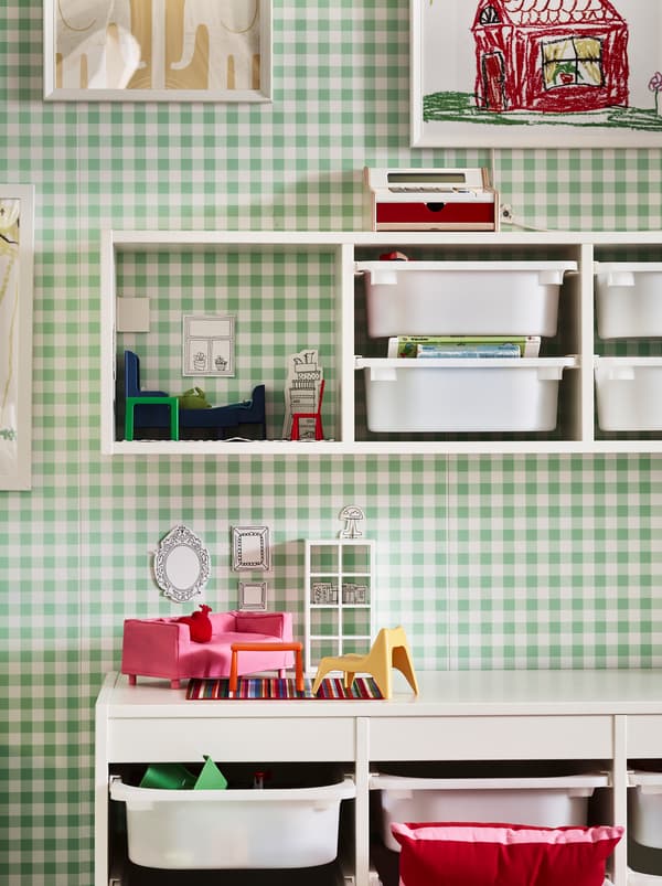 Section of a green-and-white chequered wall with TROFAST storage combinations, both fixed to the wall and on the floor.