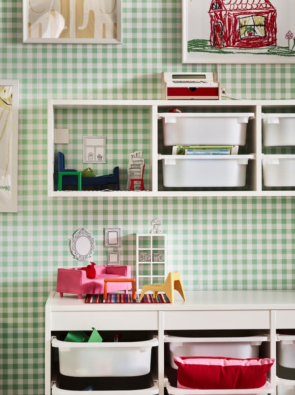 Section of a green-and-white chequered wall with TROFAST storage combinations, both fixed to the wall and on the floor.