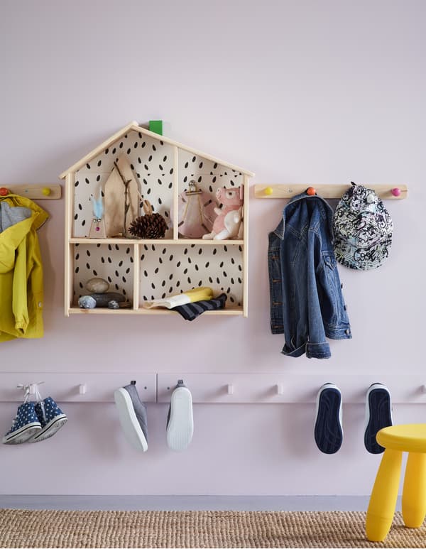 Several racks with knobs in a hallway at a height suitable for children for hanging shoes and coats.