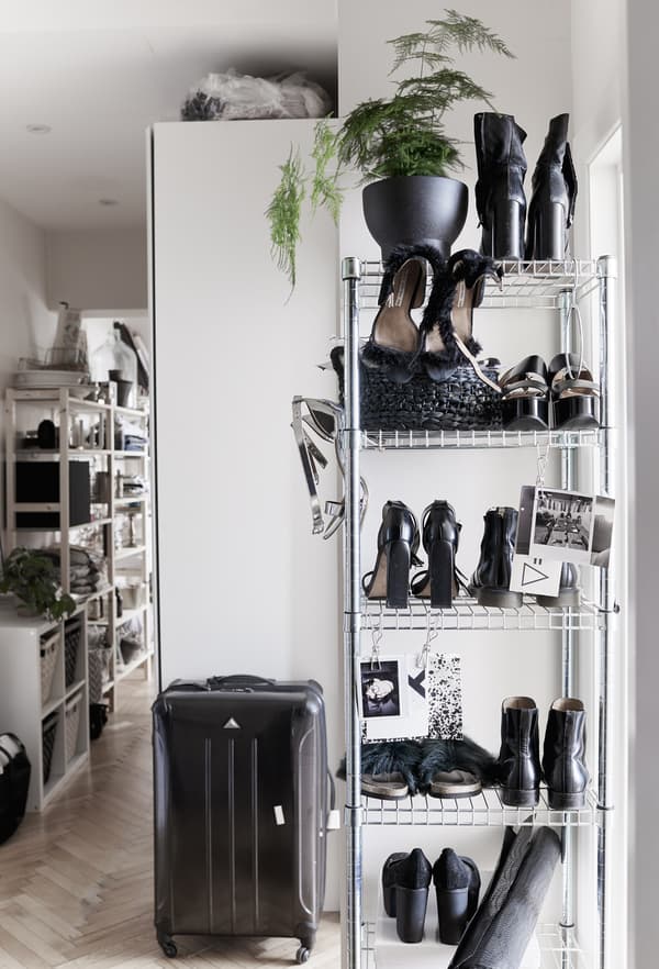 Shoes stored in a tall metal rack.