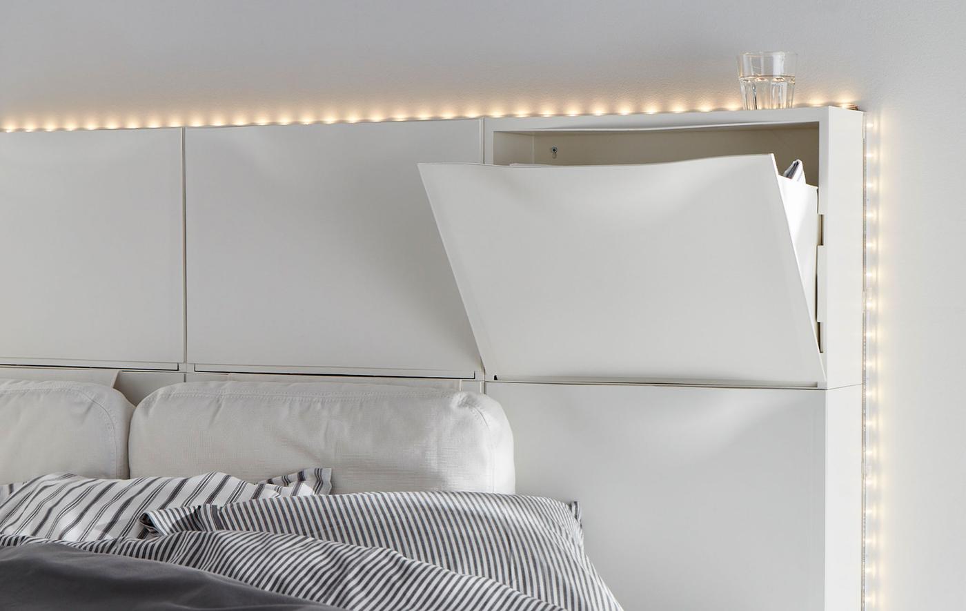 Six armoires à chaussures IKEA TRONES blanches utilisées pour créer une tête de lit.