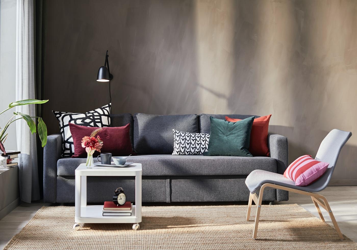Small living room design with gray sofa, white table and a black lamp.