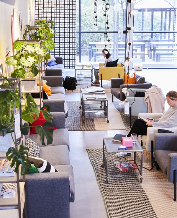 Sofas, armchairs and coffee tables in an open-plan workspace.