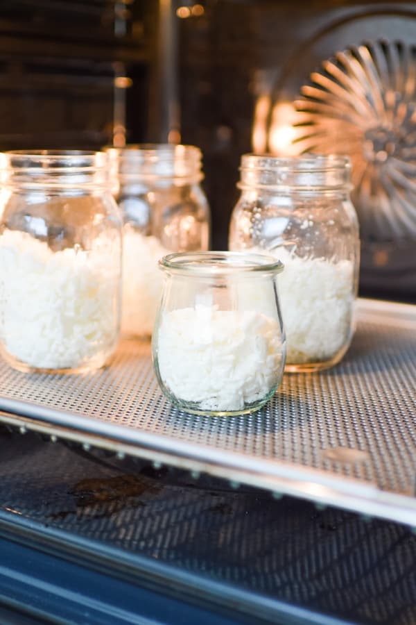 Soy wax in jars placed in an oven