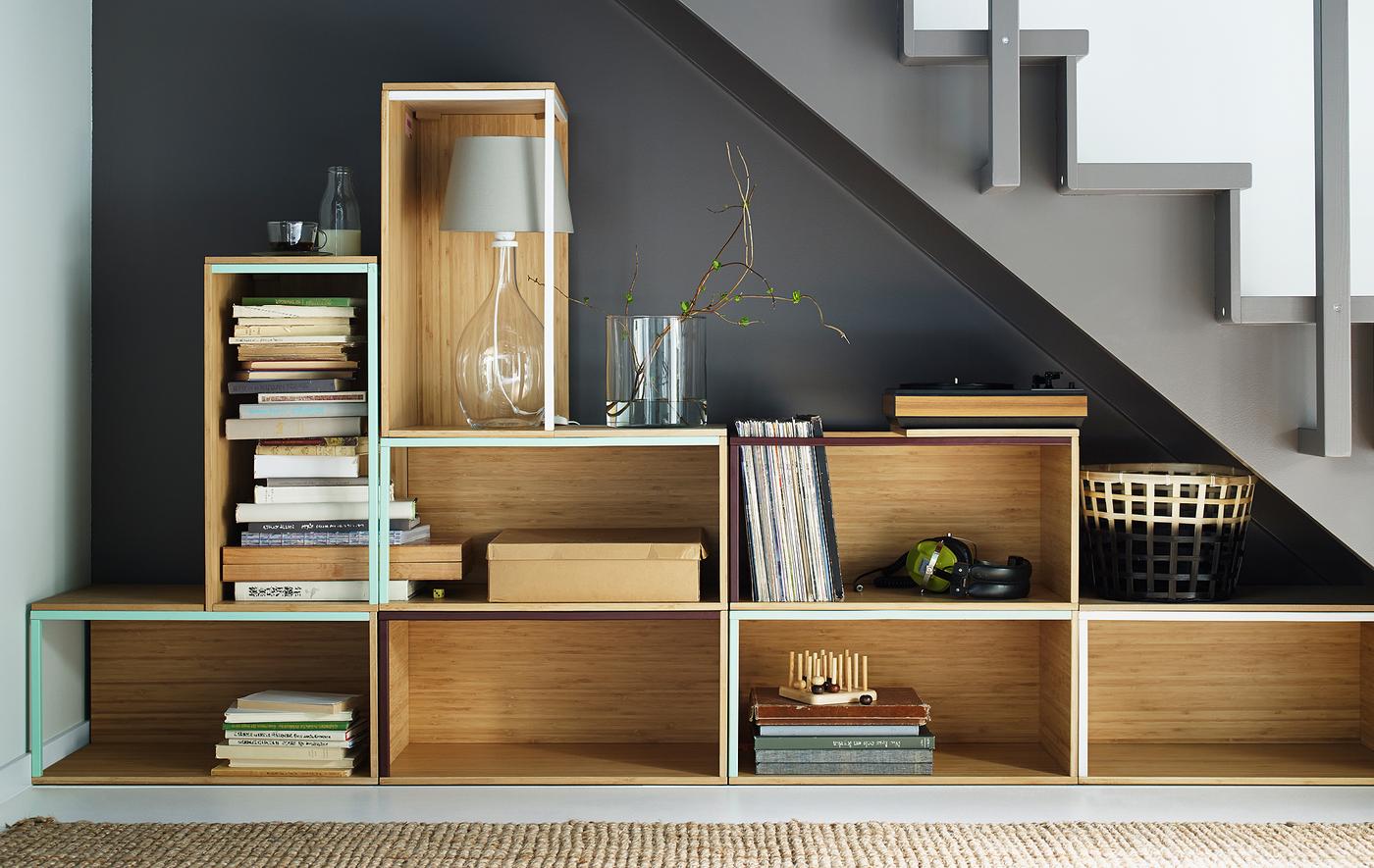 Stacked arrangement of IKEA storage boxes under a stairway.