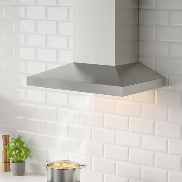 Stainless steel extractor hood mounted to wall
