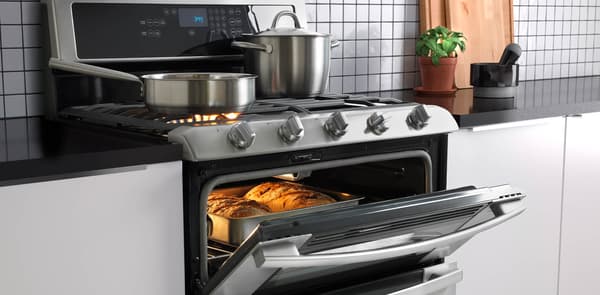 stainless steel oven with gas cooktop in kitchen