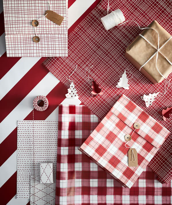 Station for gift-wrapping with all in place: paper in various colours and patterns, string, scissors, tags and boxed gifts.