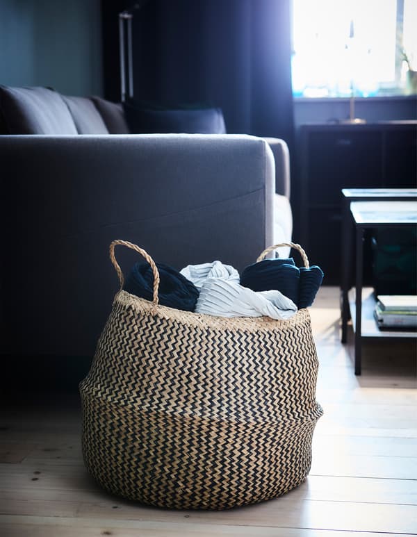 Storage isn’t more than shelving and boxes. Try using a decorative basket like FLÅDIS to store your living room textiles.