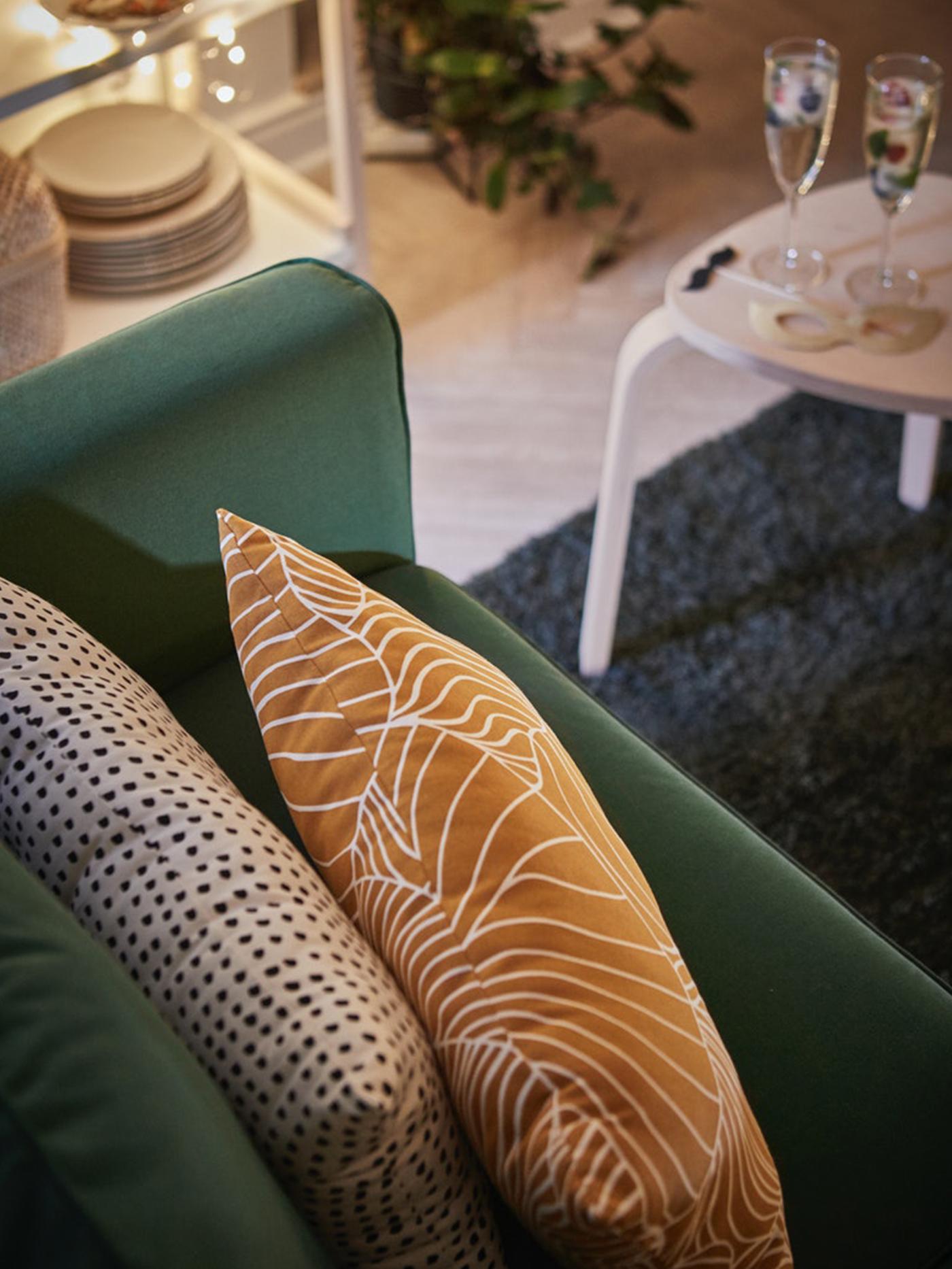 SVAMPMAL cushions on a sofa in a living room with festive setting.