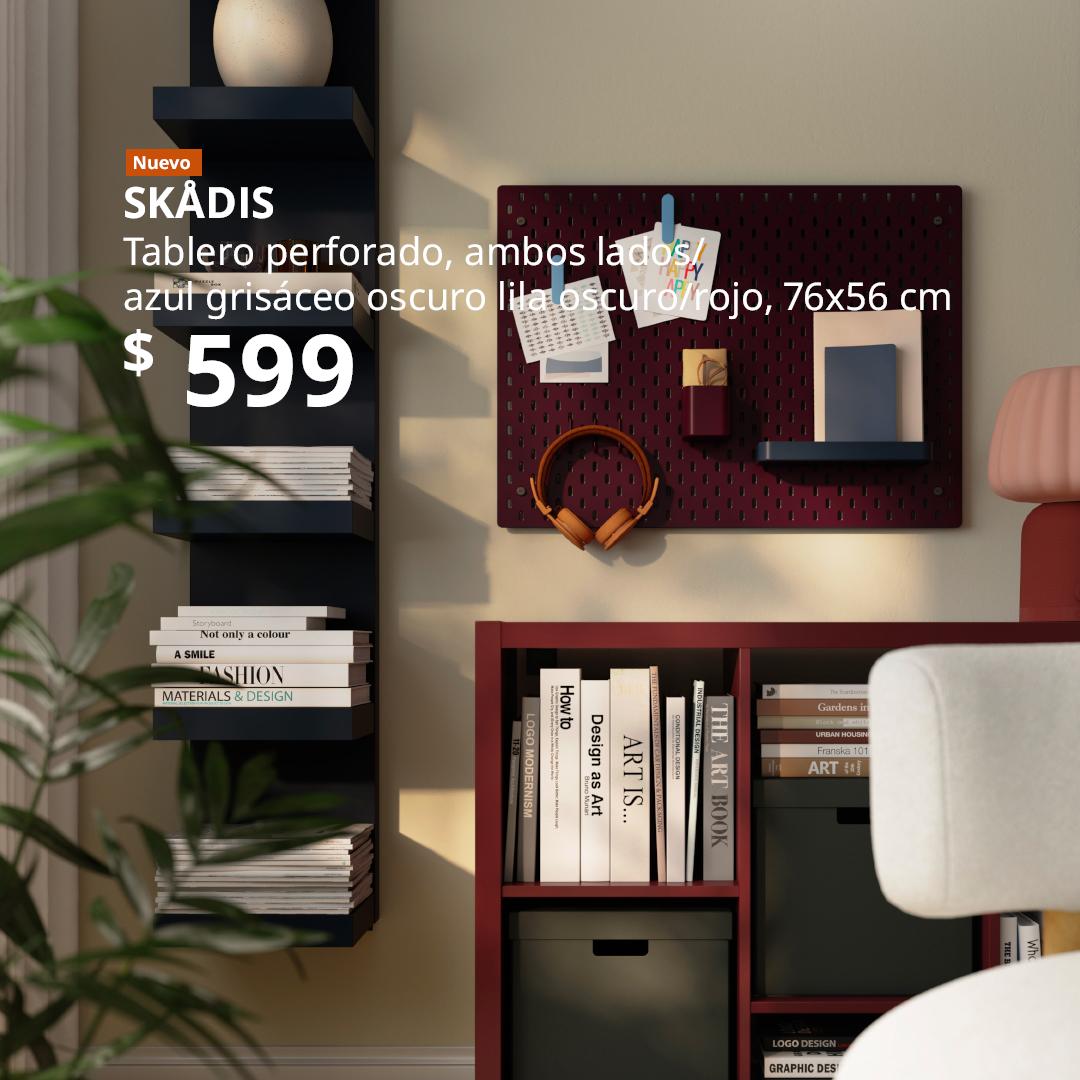 Tablero perforado SKÅDIS de doble cara en azul grisáceo oscuro y lila rojizo oscuro, organizado con audífonos, notas y accesorios en un espacio de trabajo.