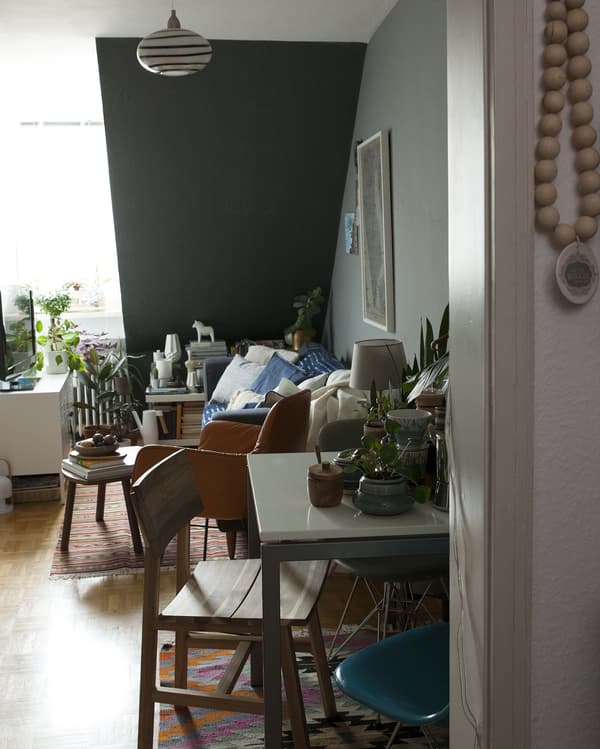 Tables and chairs smartly arranged for smaller space by a wall.