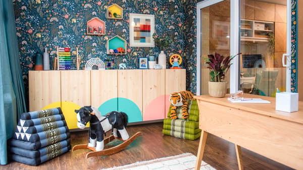 The conservatory is transformed into a multi-functional space, with a workspace and plenty of toy storage and play solutions.