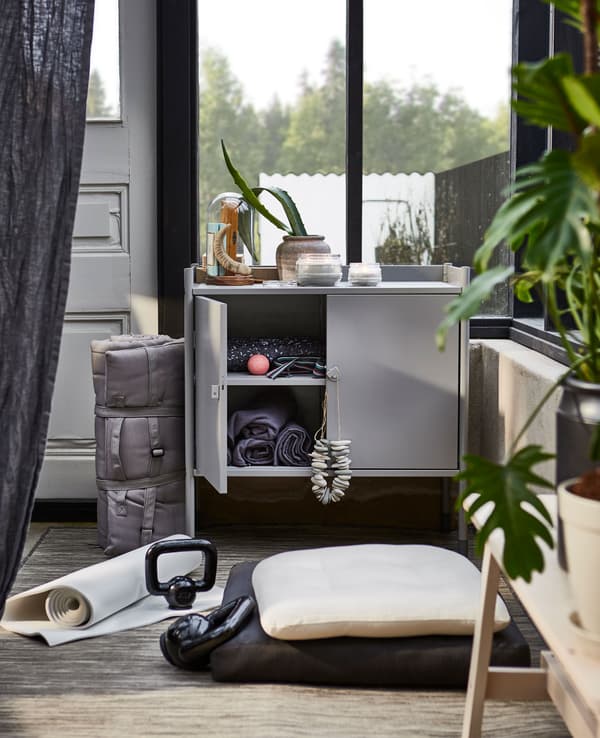 The HINDÖ indoor/outdoor cabinet works as storage space for exercise equipment.