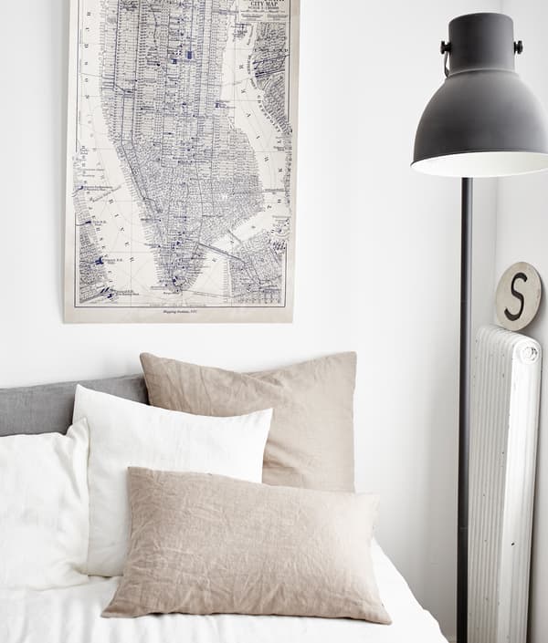 The neutral white and beige palette of these bed linens helps keep a blended live/work space calm.