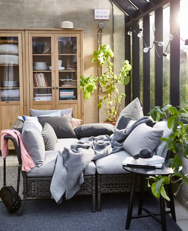 The sections in the KUNGSHOLMEN outdoor seating series are combined to form a cosy daybed.