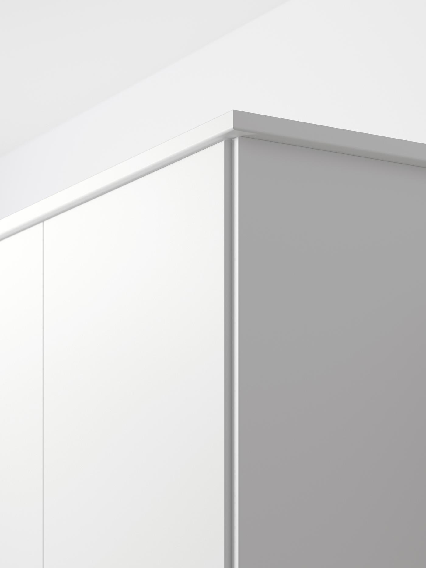 The upper corner of a white cabinet with a matt white kitchen door.