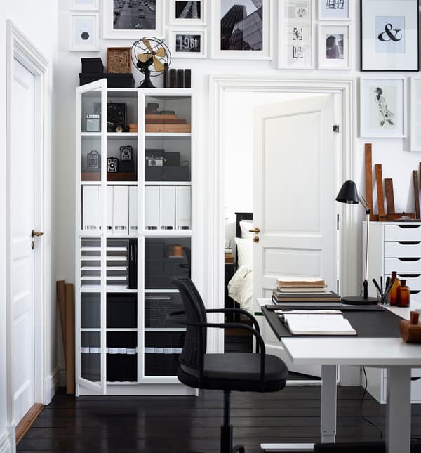 This classic home office has dark floors and white walls. The simple color combo keeps the space feeling uncluttered.