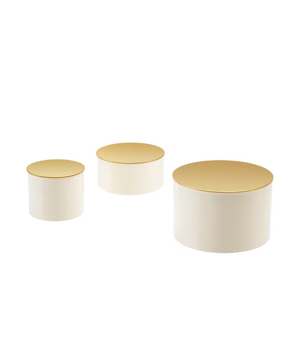 Three boxes with gold-coloured lids in different sizes.