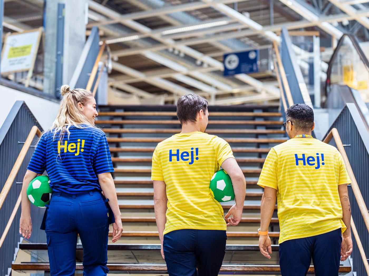 Three IKEA co-workers climbing up the stairs.