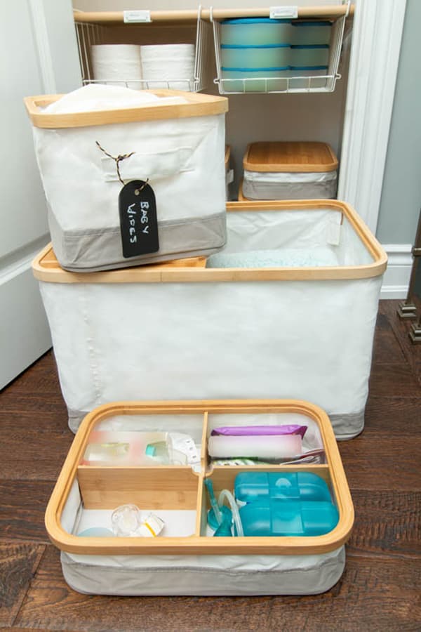 Three RABBLA storage boxes with bamboo lids, one with four compartments, used to store baby necessities. 