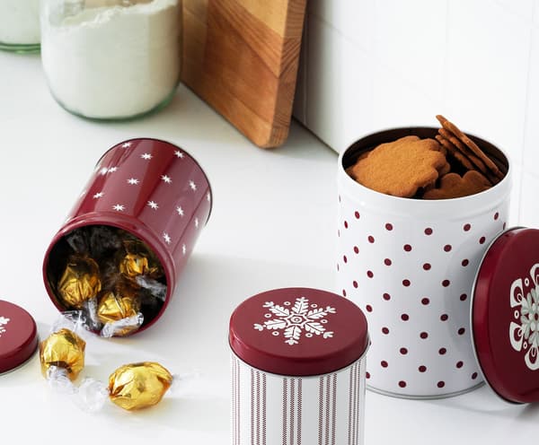 Three-tier VINTERFEST serving stand on a table with savouries and sweet cakes.