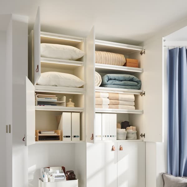 Three wall cabinets filled with pillows, blankets, and office accessories, with MISSMRYA sensor lighting strips installed