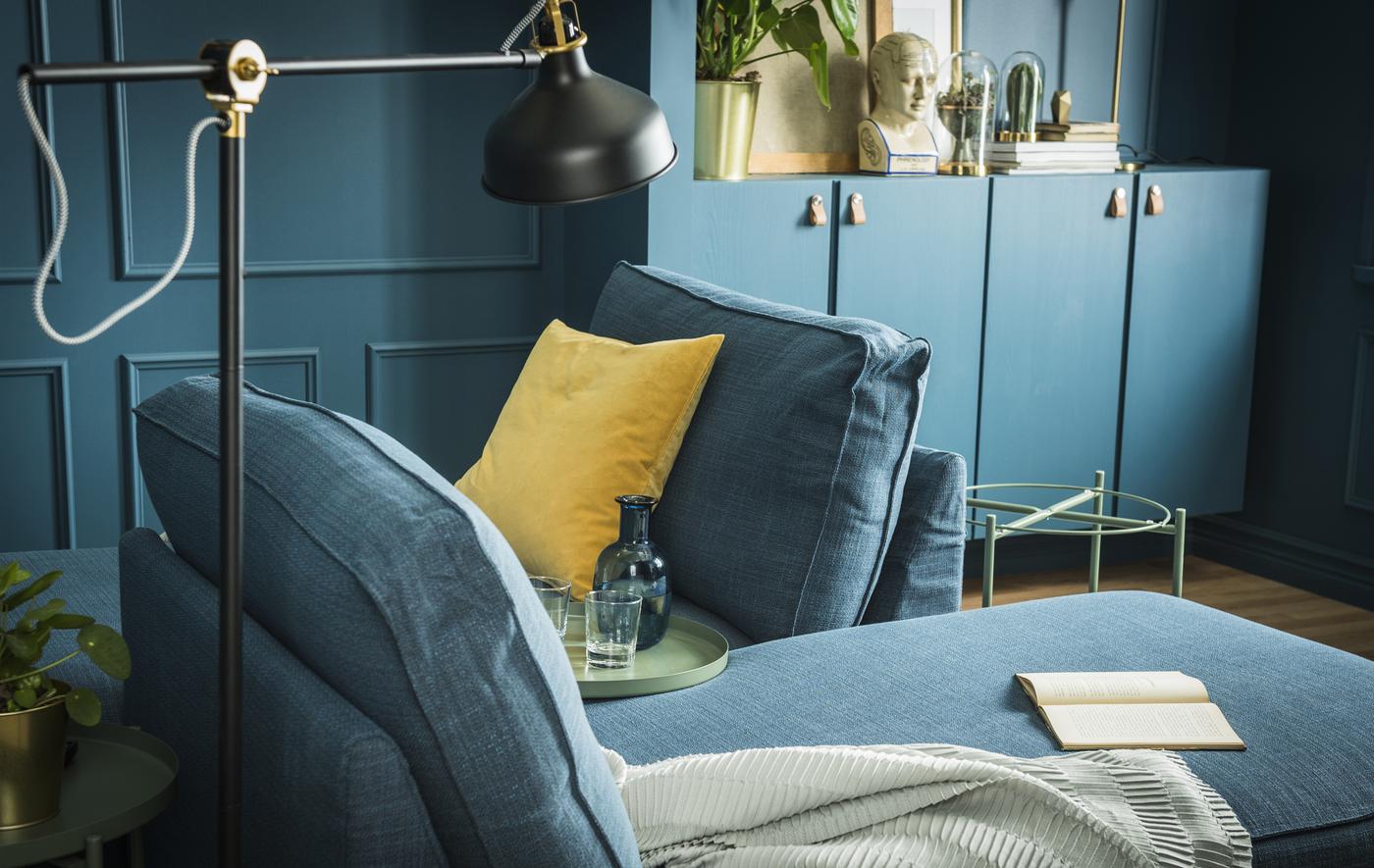 To chaise lounges furnish a living room painted in deep shades of green.