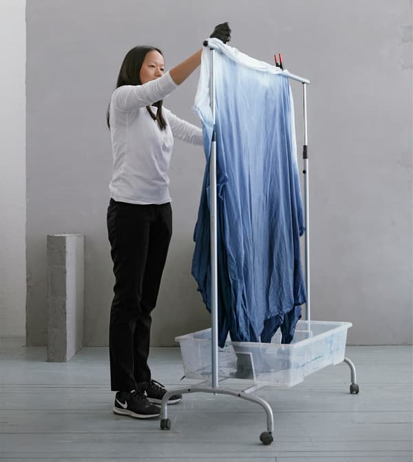 To make unique bedding for your dorm, you can dye cotton fabric like BOMULL from IKEA. We used a clothes rack as a drying rack with a plastic bin underneath to catch drips.   