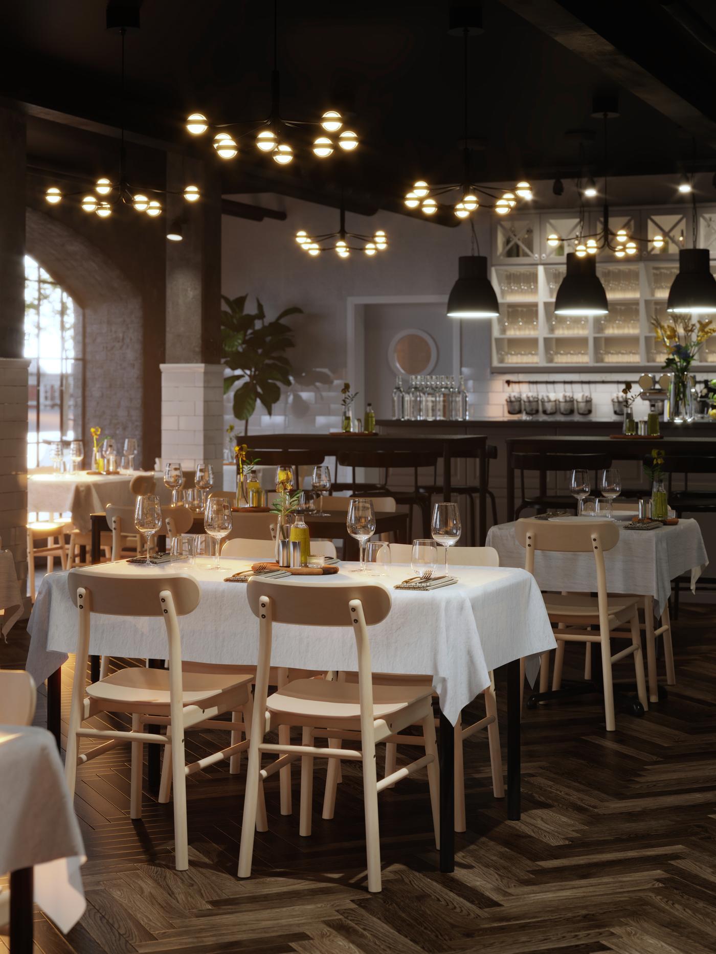 TOMMARYD tables set for dining with white tablecloths, STORSINT wine glasses and flowers in a spacious restaurant with parquet floors.