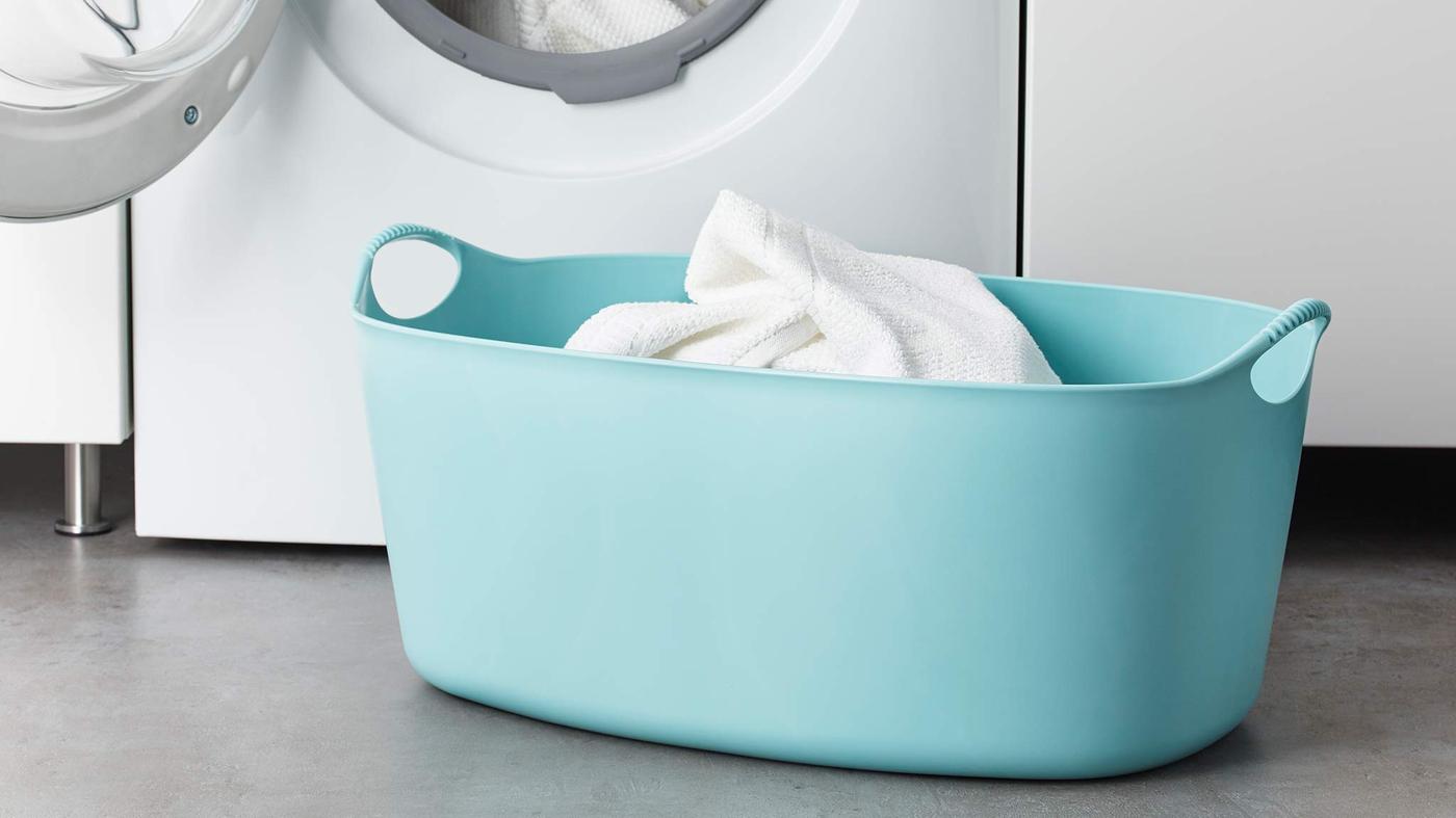 TORKIS basket in front of a while washing machine.